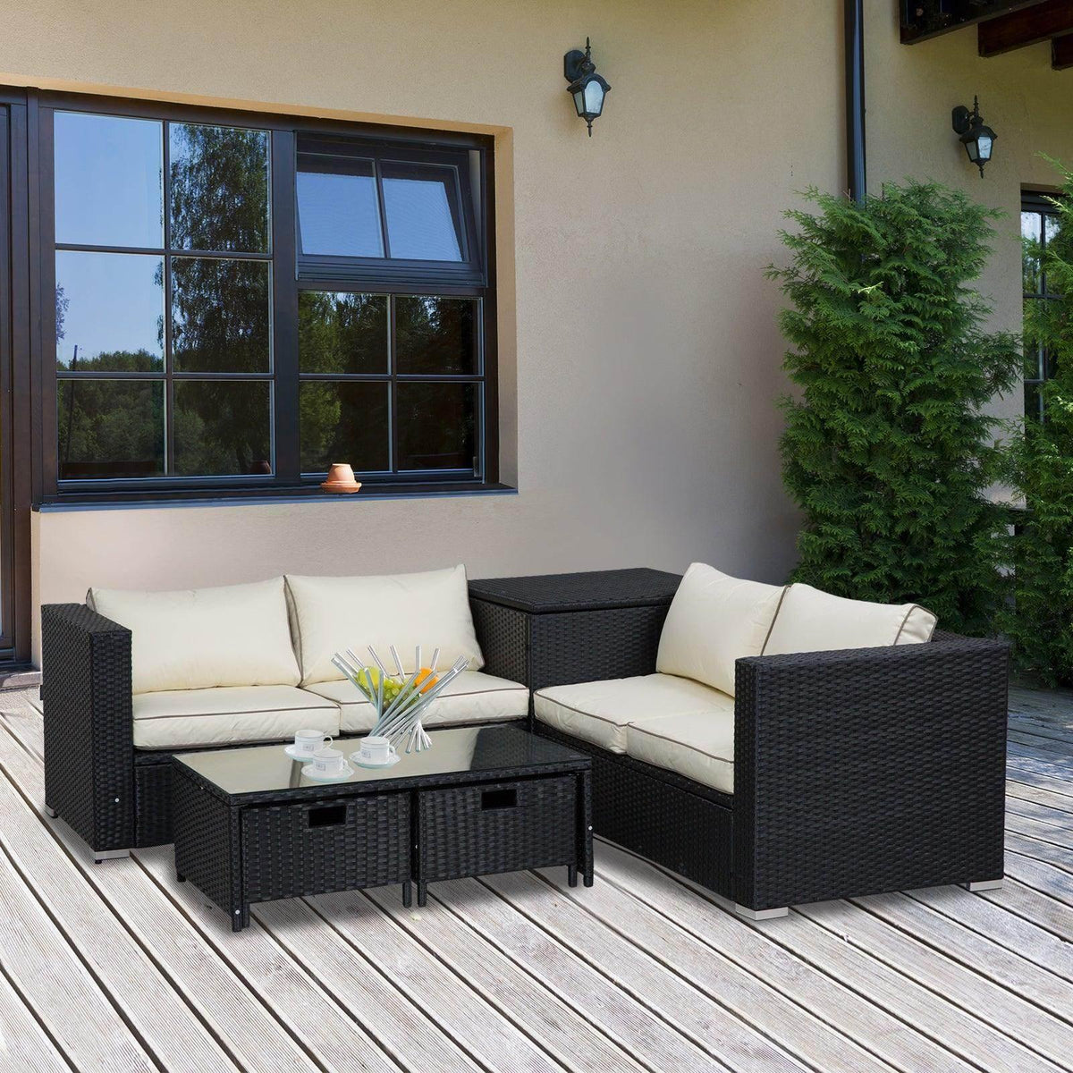 Black outdoor patio sofa set with corner seats, cream cushions, and a glass-top table