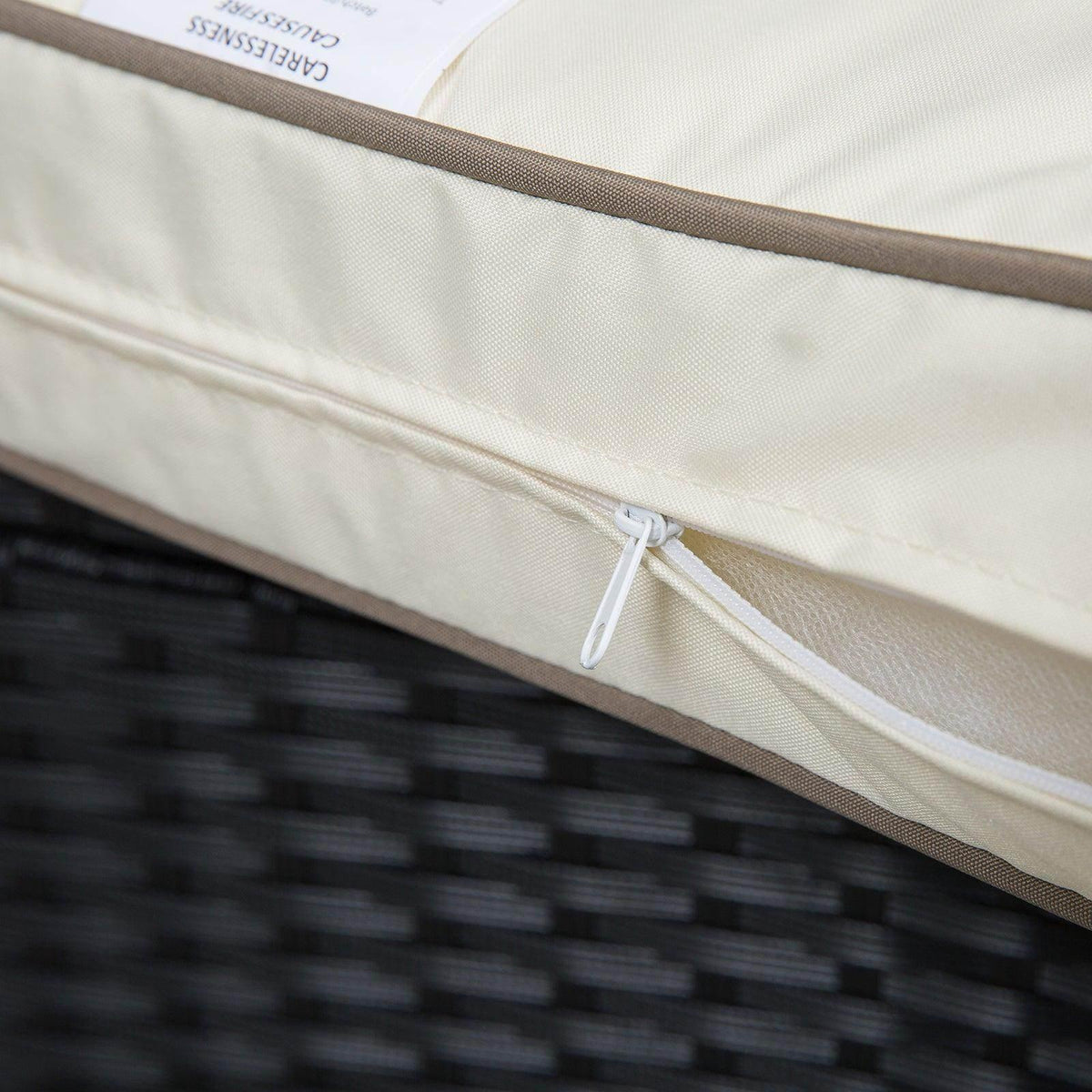 Close-up of cream outdoor cushion fabric with visible zipper along the seam