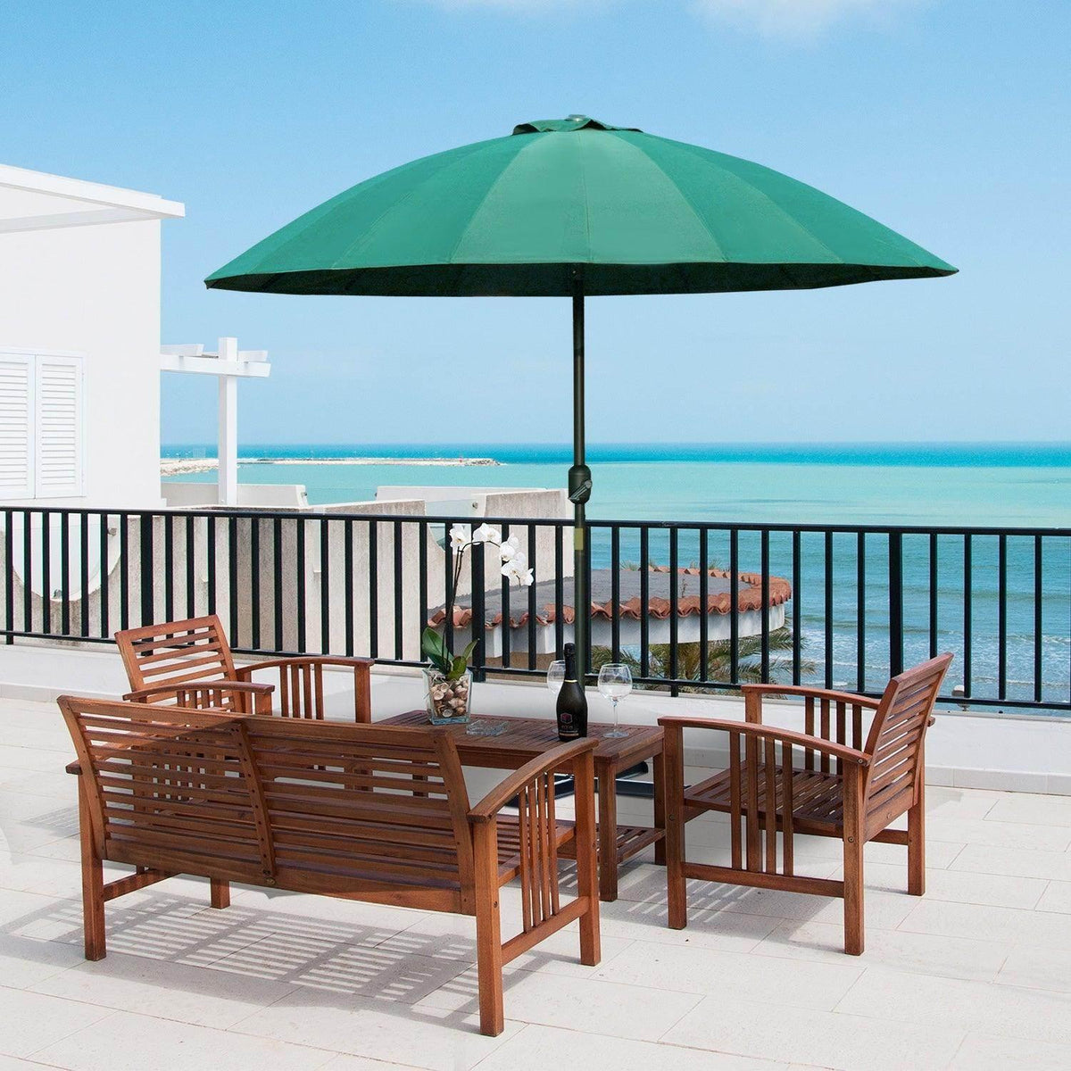 Green patio umbrella with open canopy on a central pole above outdoor seating