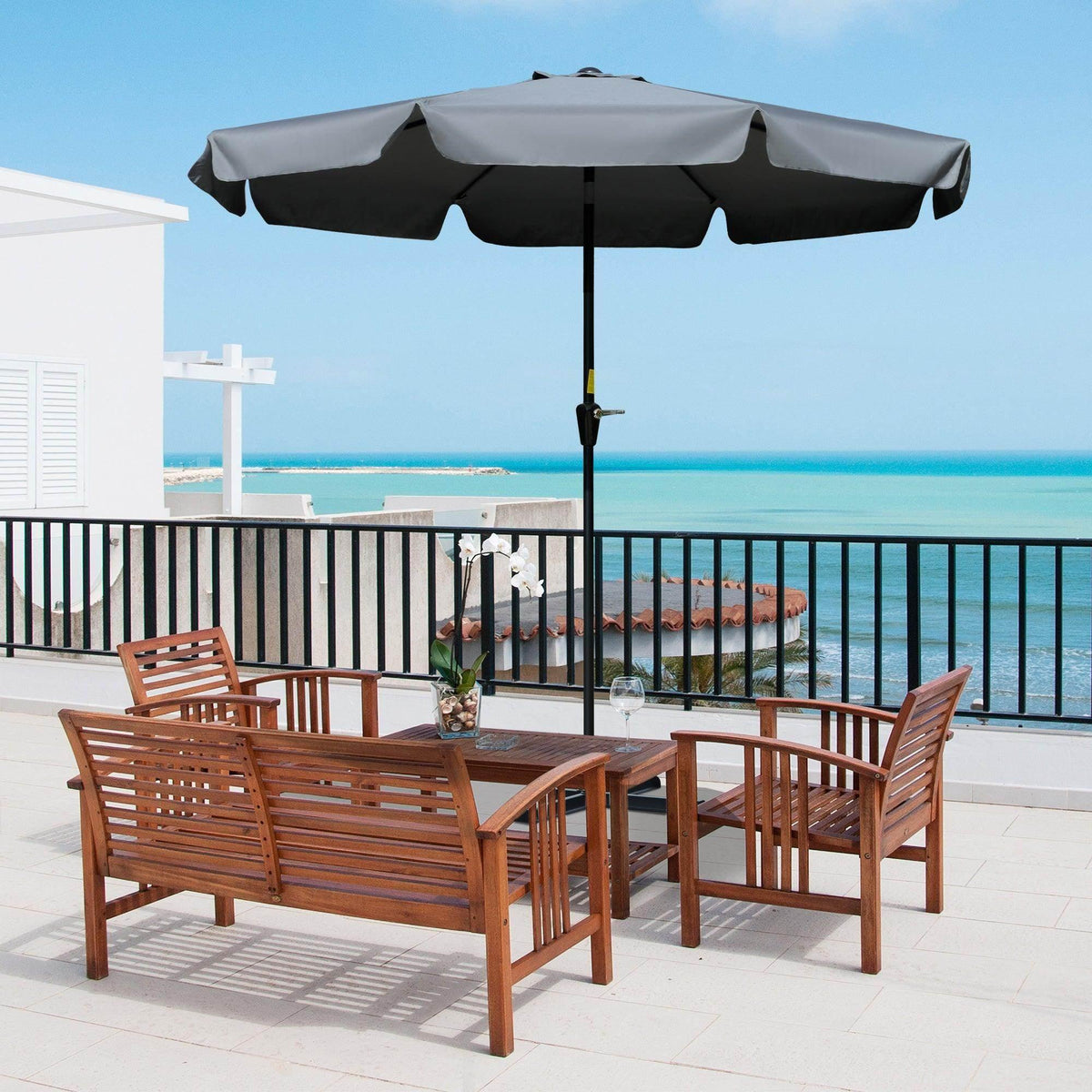 Outdoor patio umbrella with dark gray ruffled canopy edge and black center pole
