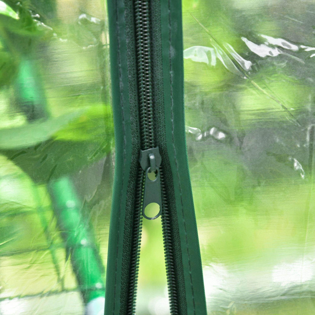 Greenhouse door zipper detail on clear PE cover with green frame post