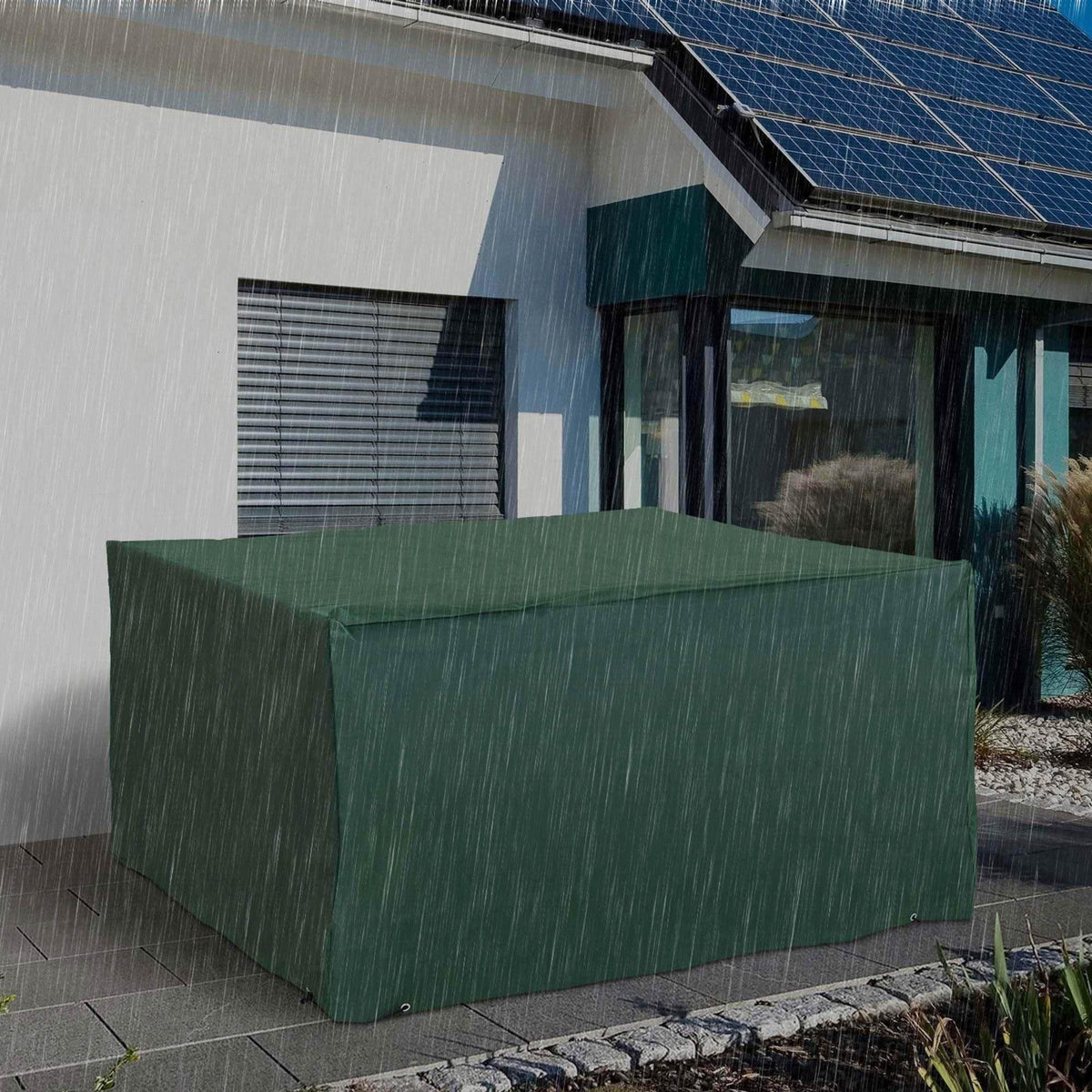 Green waterproof garden furniture cover protecting outdoor patio set in heavy rain