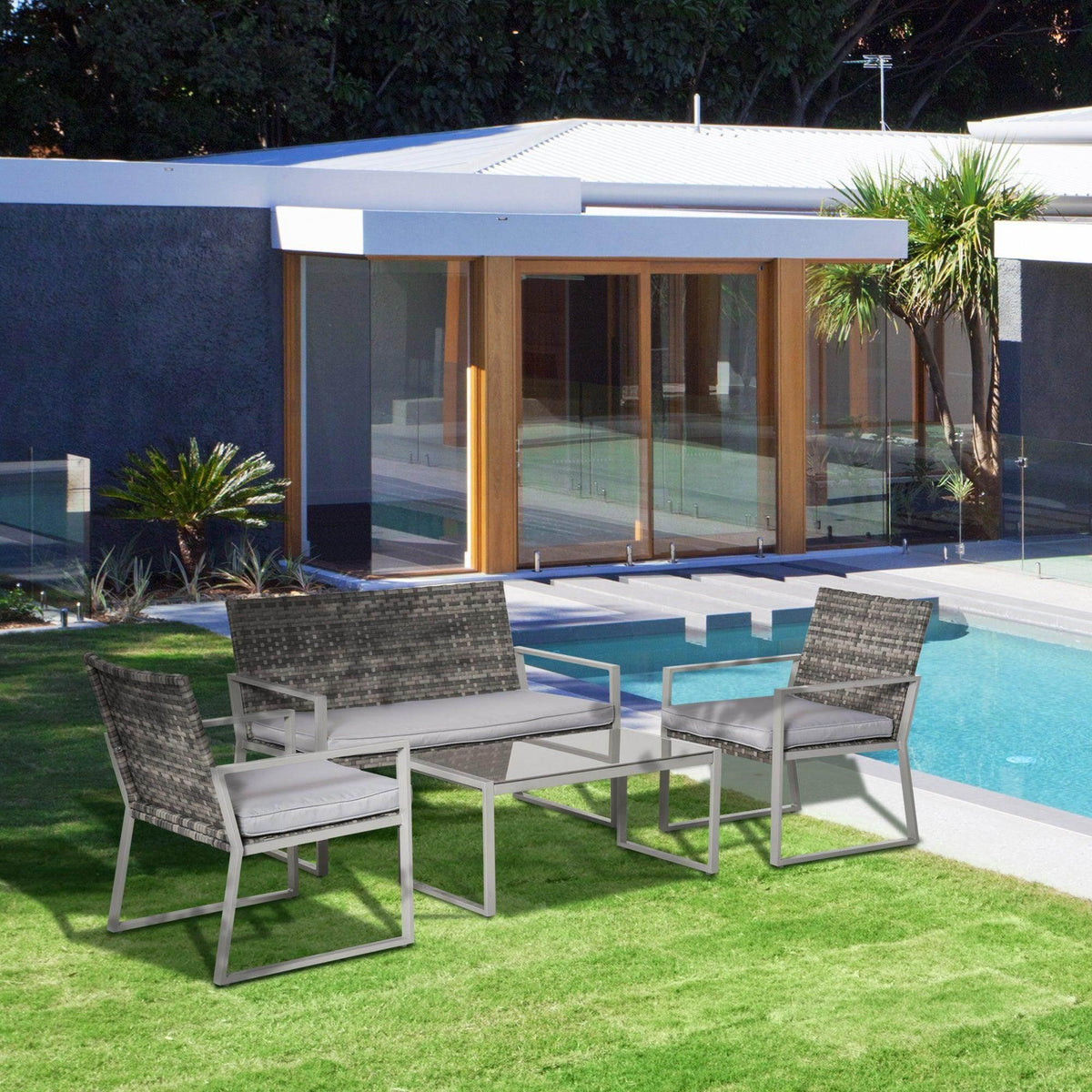 Gray resin wicker 4-seat patio furniture set with seat cushions and coffee table by pool