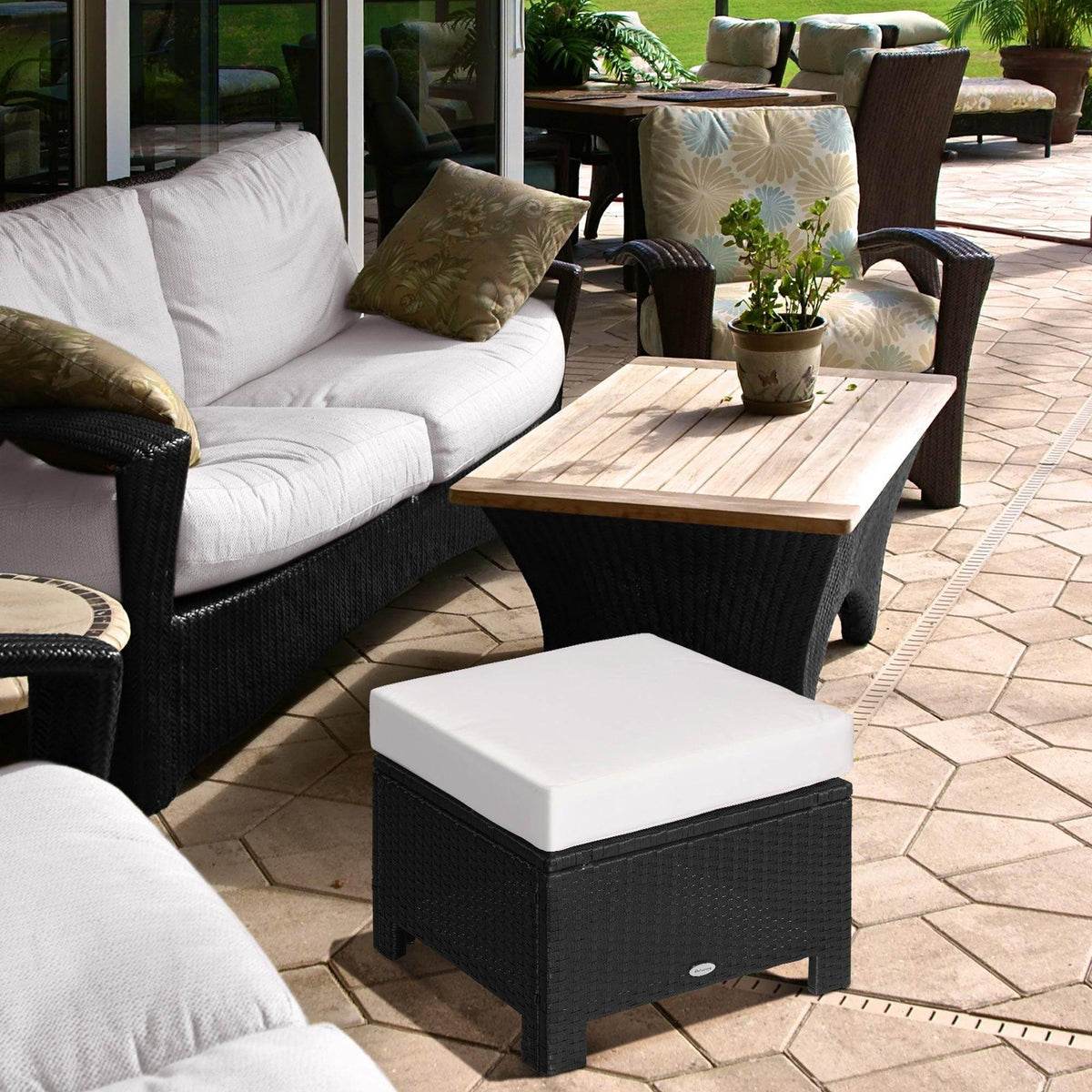 Black rattan ottoman with white cushioned seat, square top