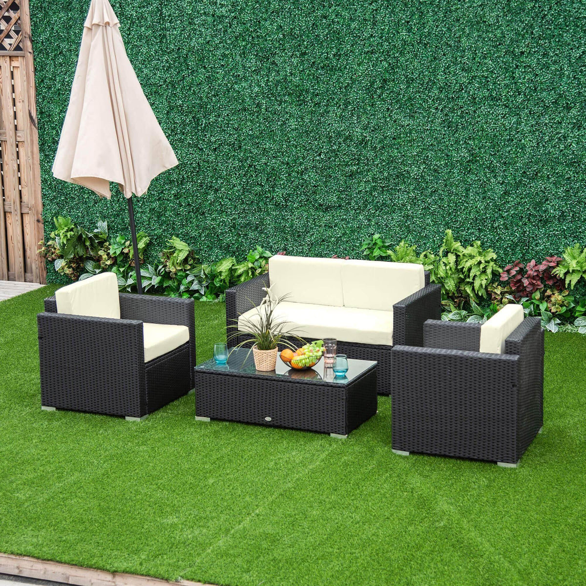Rattan patio sofa set with dark woven seats, white cushions, and square glass coffee table
