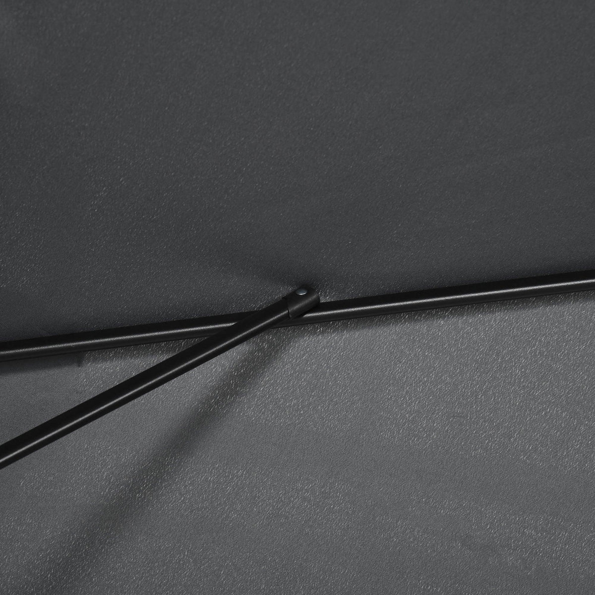 Close-up of black patio umbrella fabric with stitched seam and support bar