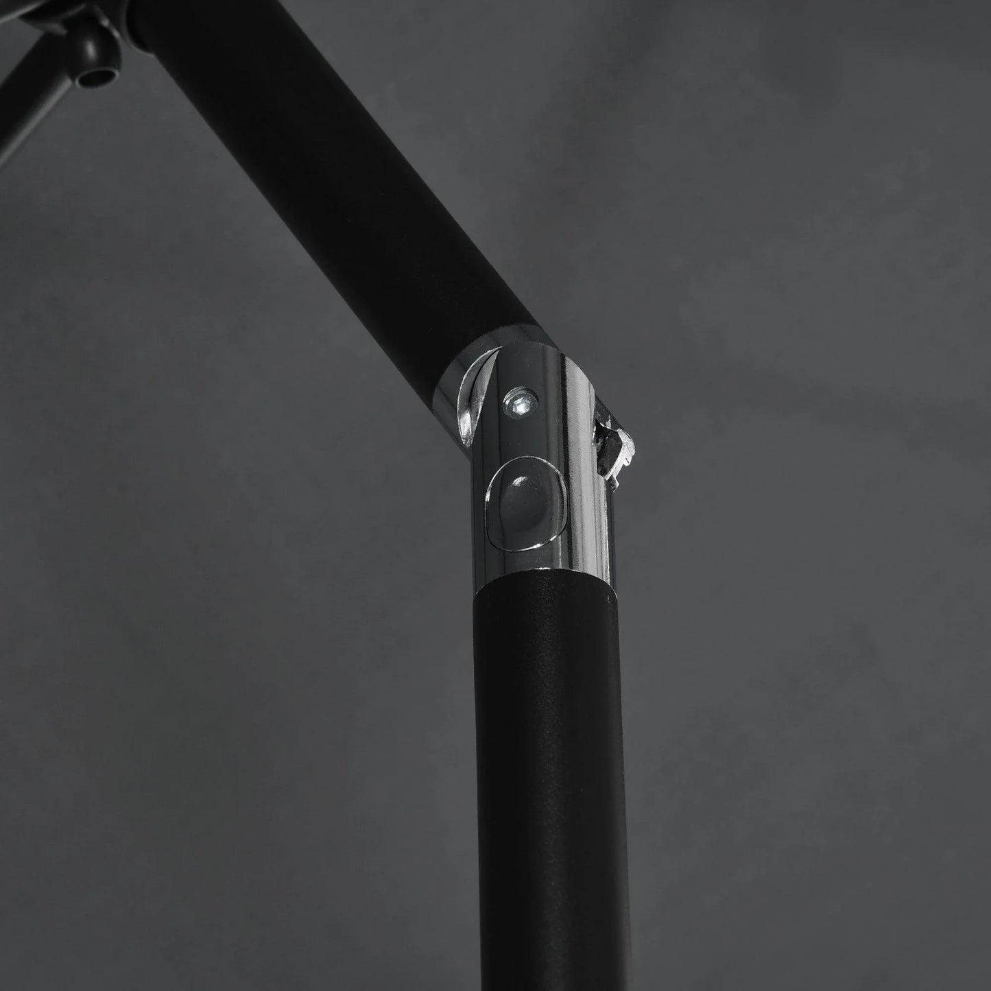 Close-up of black tilt crank base on rectangular patio umbrella center pole