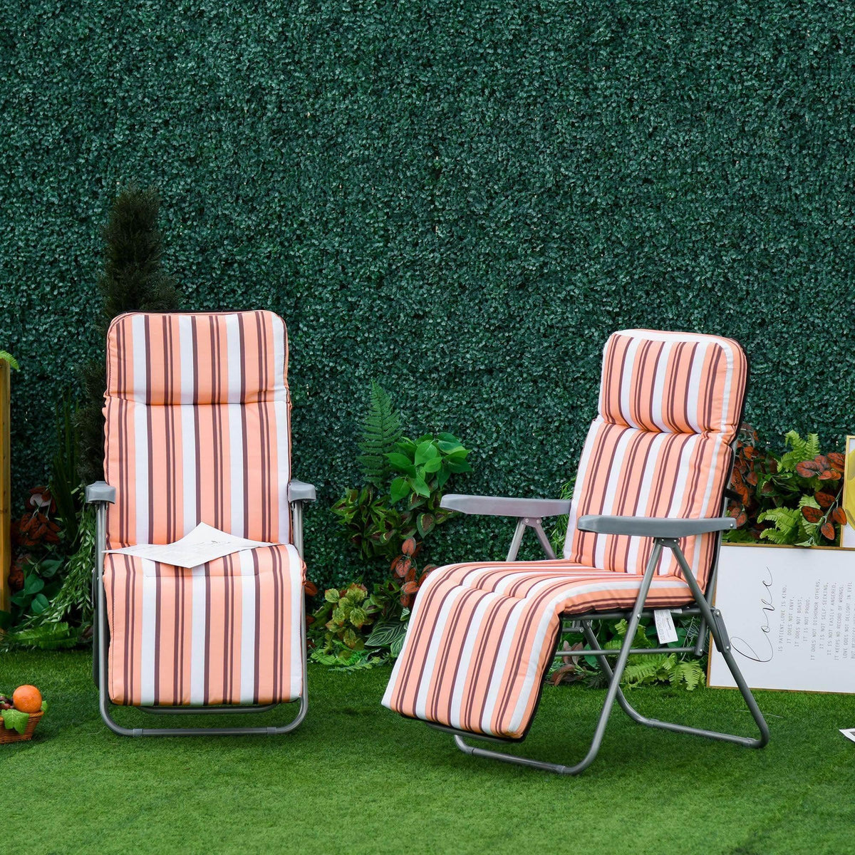 Striped outdoor recliner chairs on grass, perfect for garden relaxation and patio comfort.
