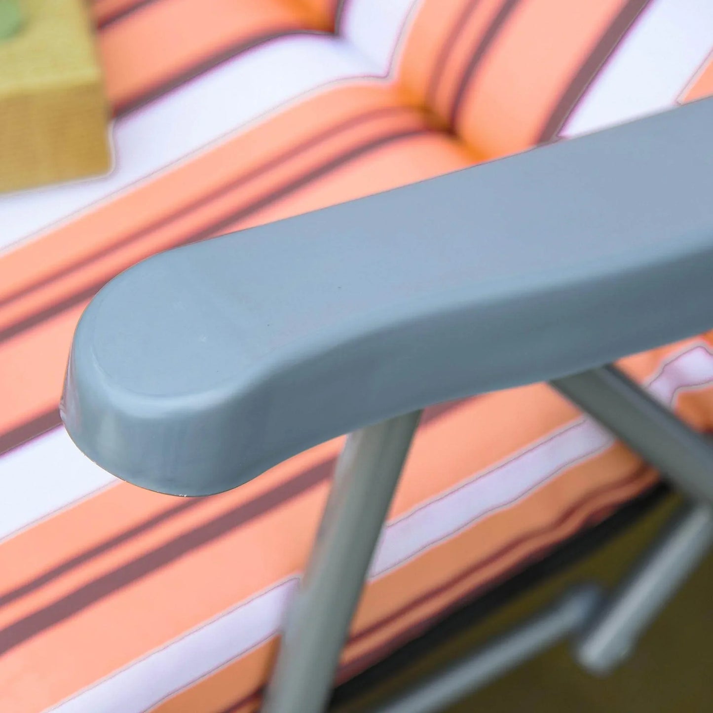 Close-up of a grey armrest on an orange and white striped garden sun lounger at ALL4U Retailer LTD
