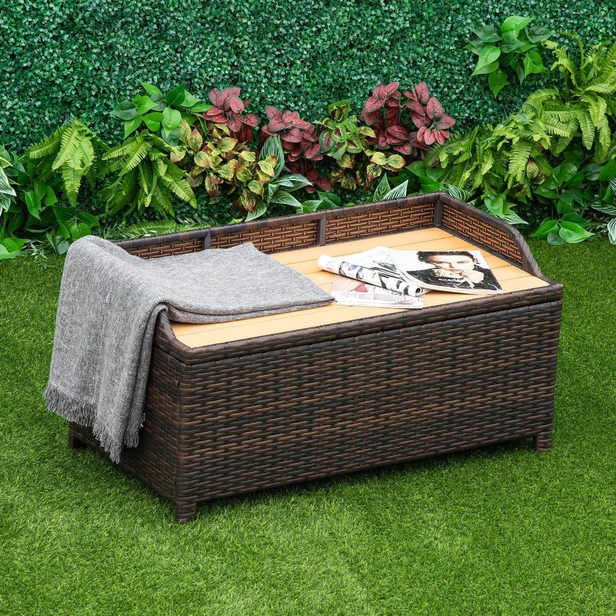 Brown woven storage bench with hinged lid and gray cushion, open top compartment