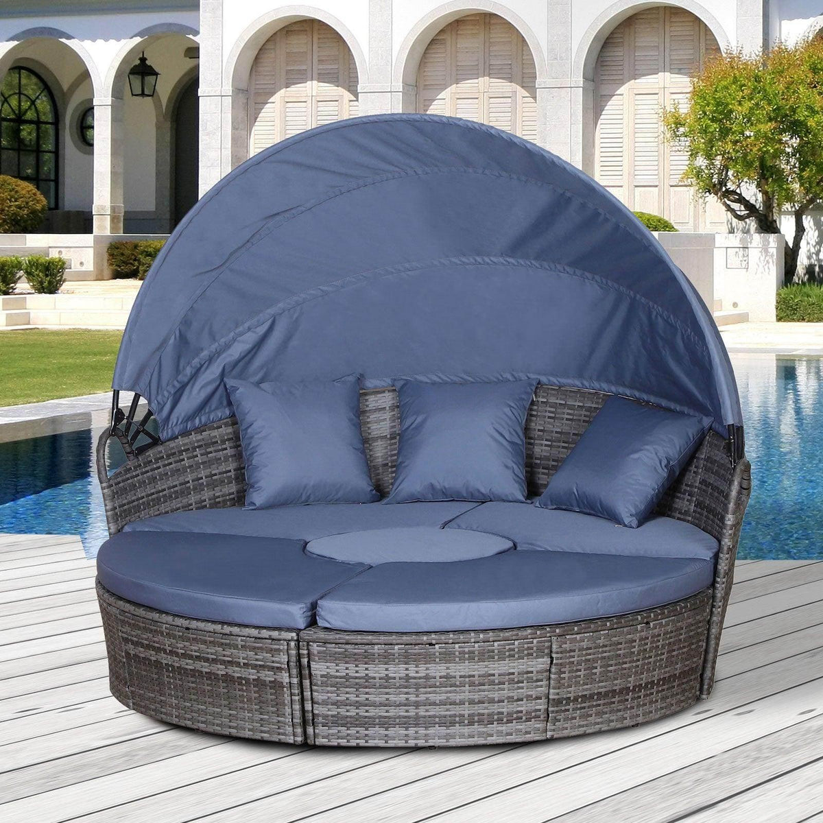 Round wicker sofa bed with dark grey weave, blue cushions, and arched canopy cover