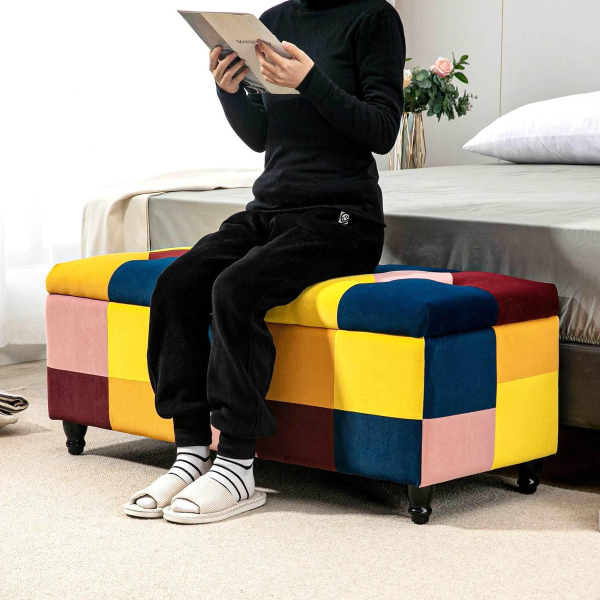 Patchwork velvet storage ottoman with hinged lid, multicolor block pattern, in use