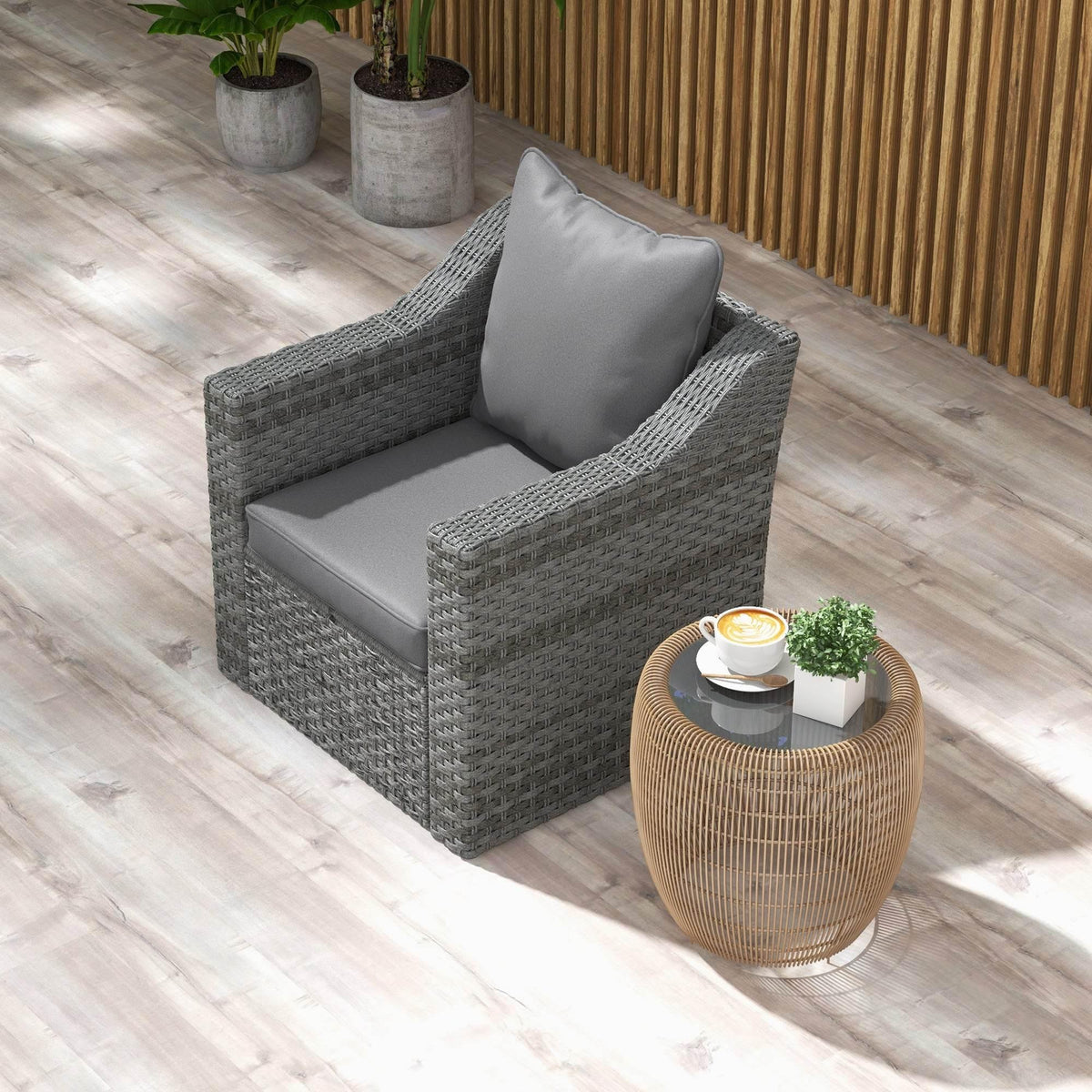 Charcoal grey patio chair cushion set on a woven armchair
