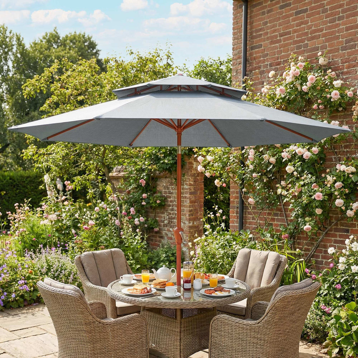 Light grey double-top garden parasol on orange pole over outdoor patio table