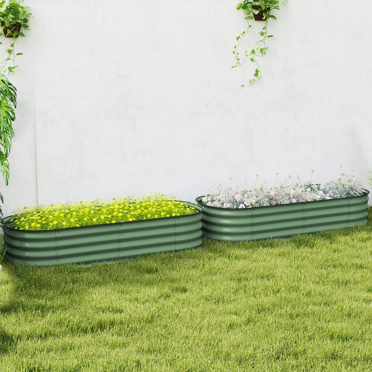 Two green metal raised garden beds with safety edging on lawn, filled with plants
