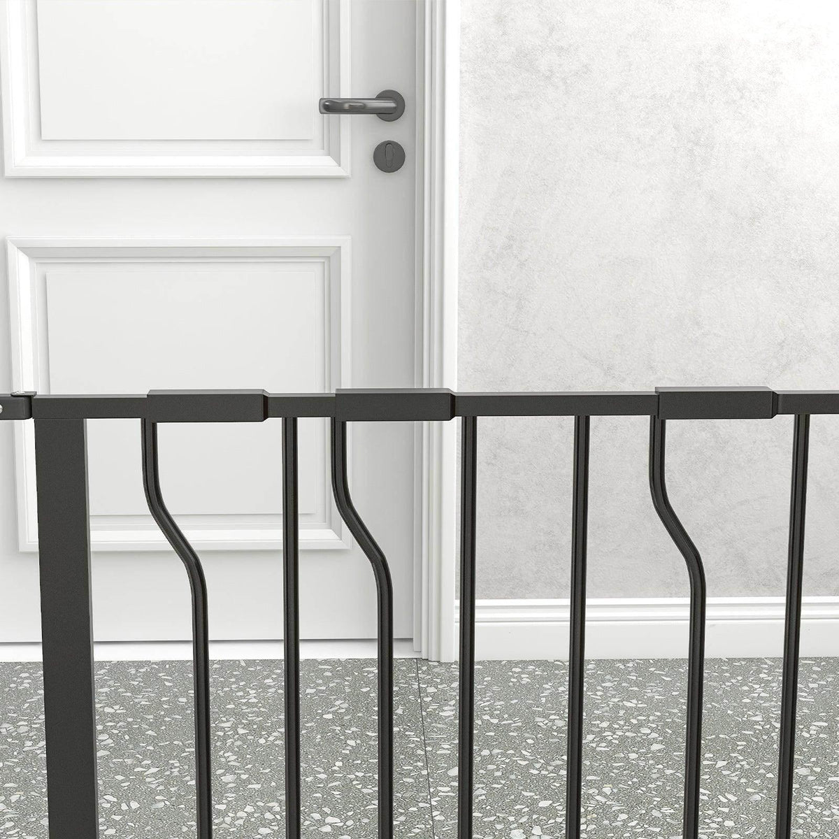 Black top rail and locking bracket on a dog safety gate with vertical bars