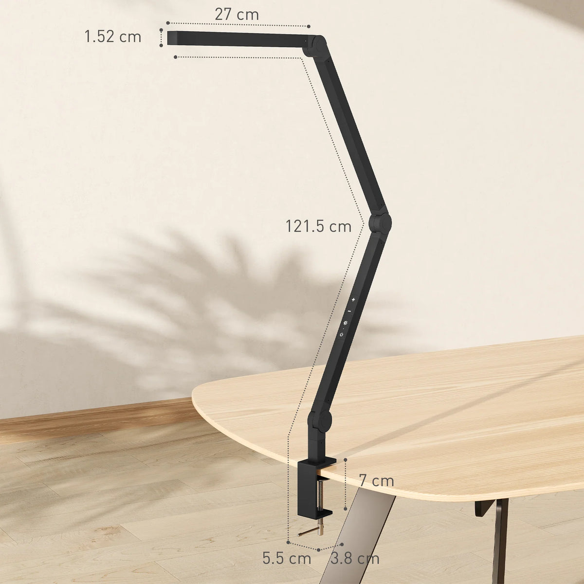 Black LED swing arm desk lamp with clamp base on desk edge, side view