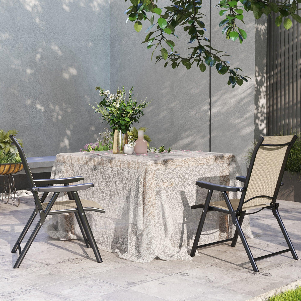 Two folding outdoor chairs with tan breathable mesh backs and seats on black frames