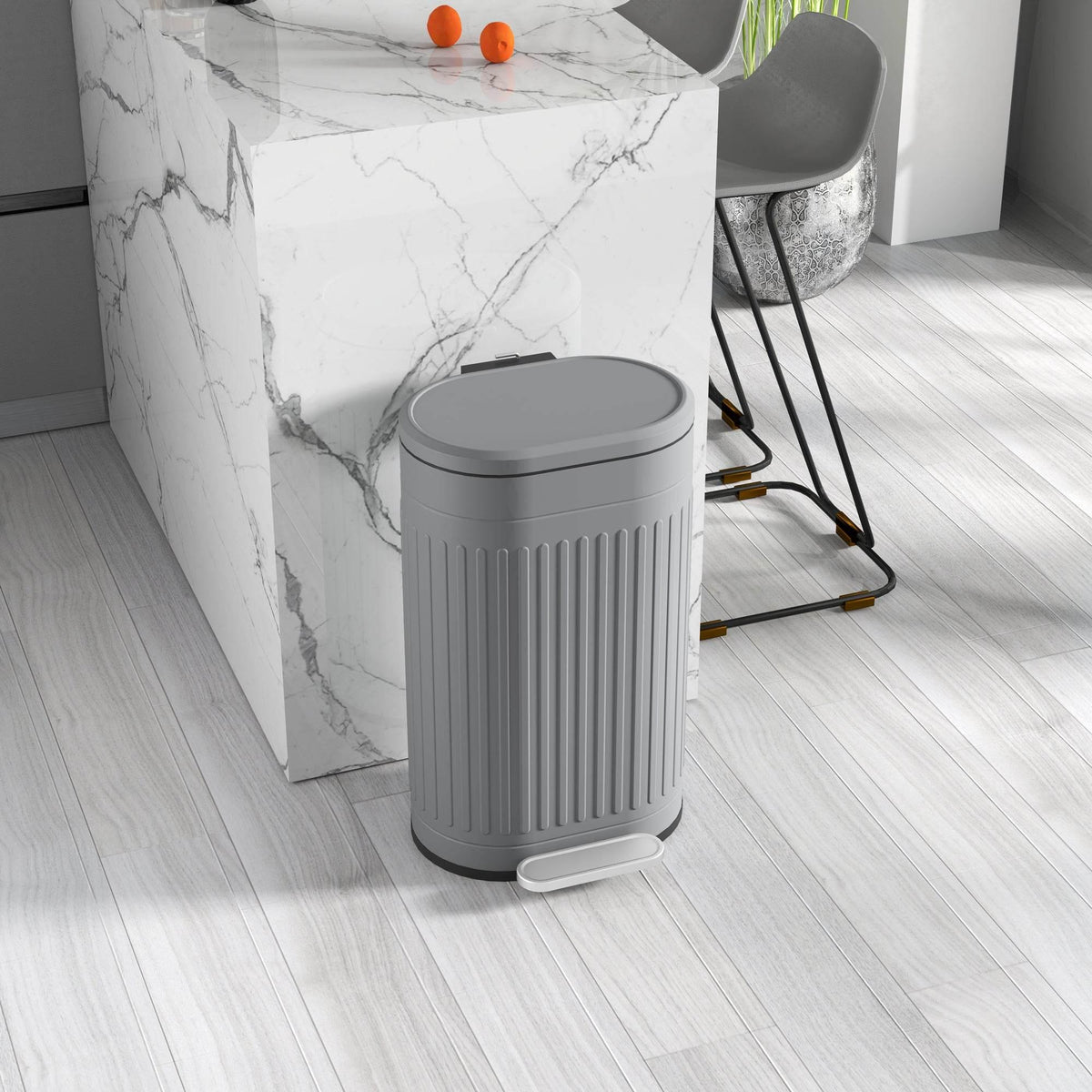 Grey pedal trash can with rounded lid and ribbed sides, closed
