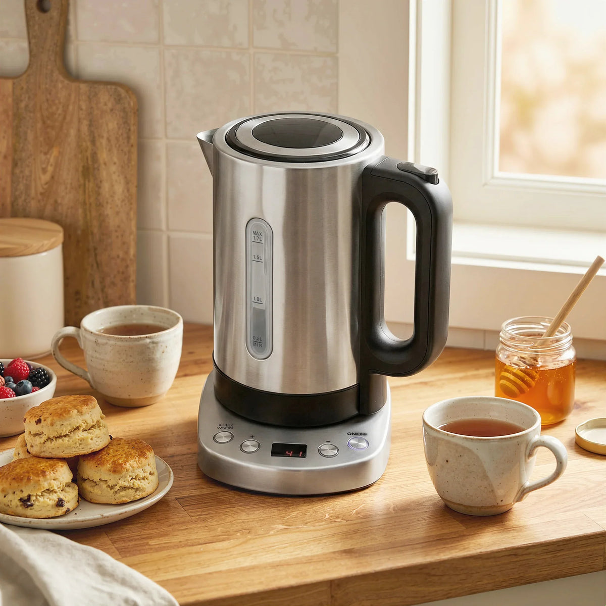 Silver electric kettle with black handle and base, sitting on a countertop