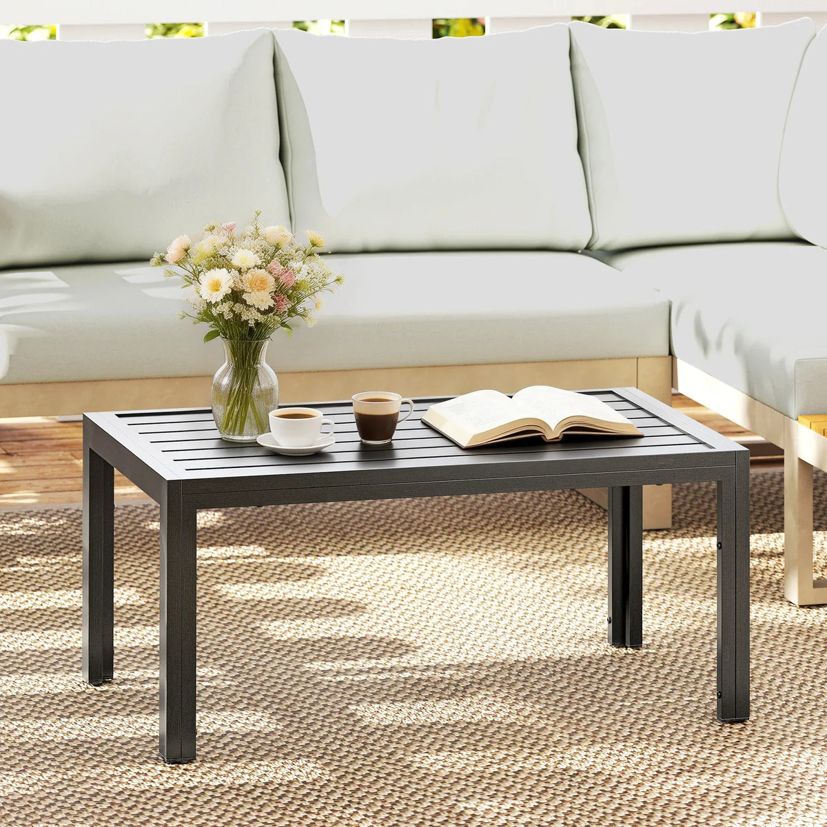 Grey outdoor rectangular side table with striped slat top and four straight legs