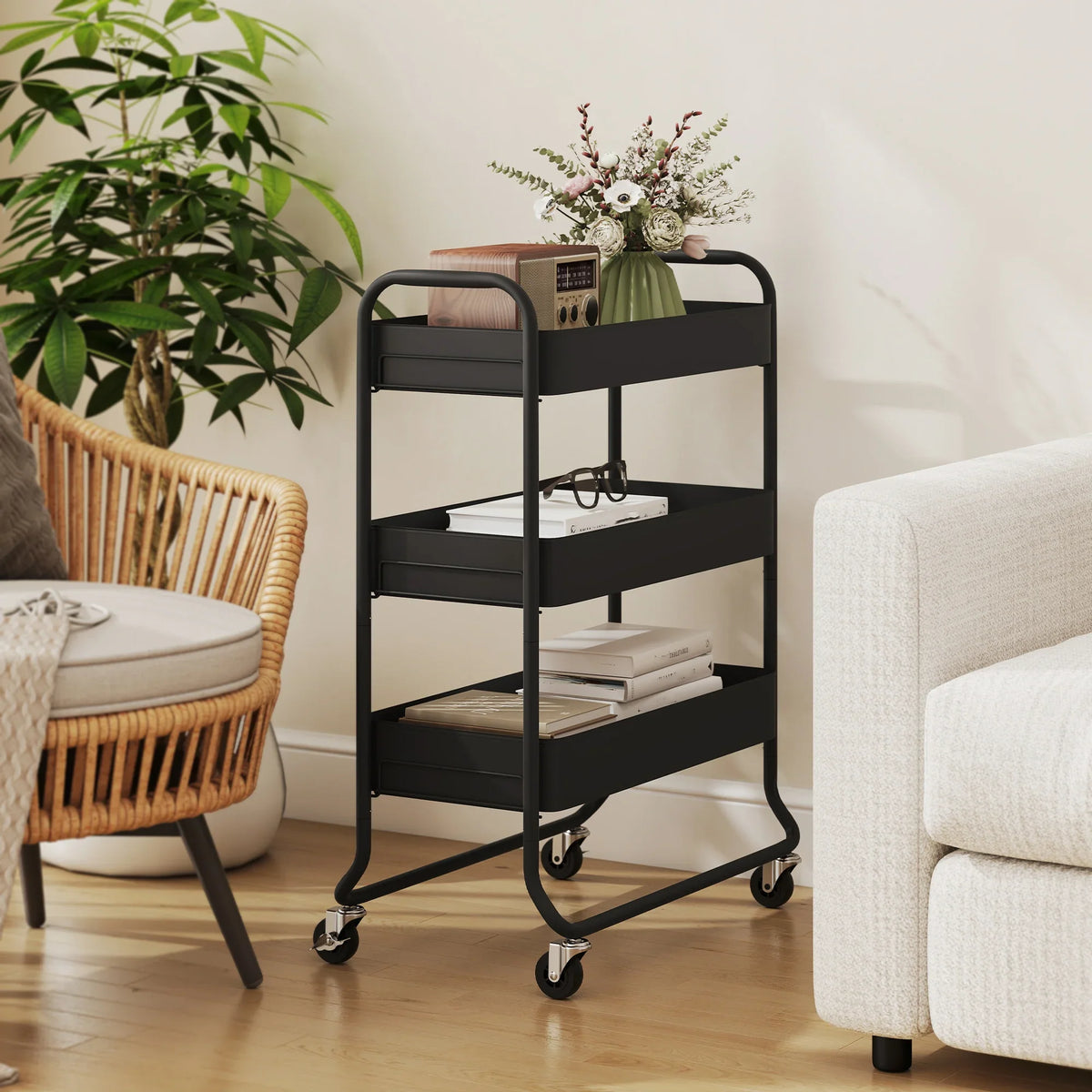 Black 3-tier storage trolley with mesh baskets, books and small decor on shelves
