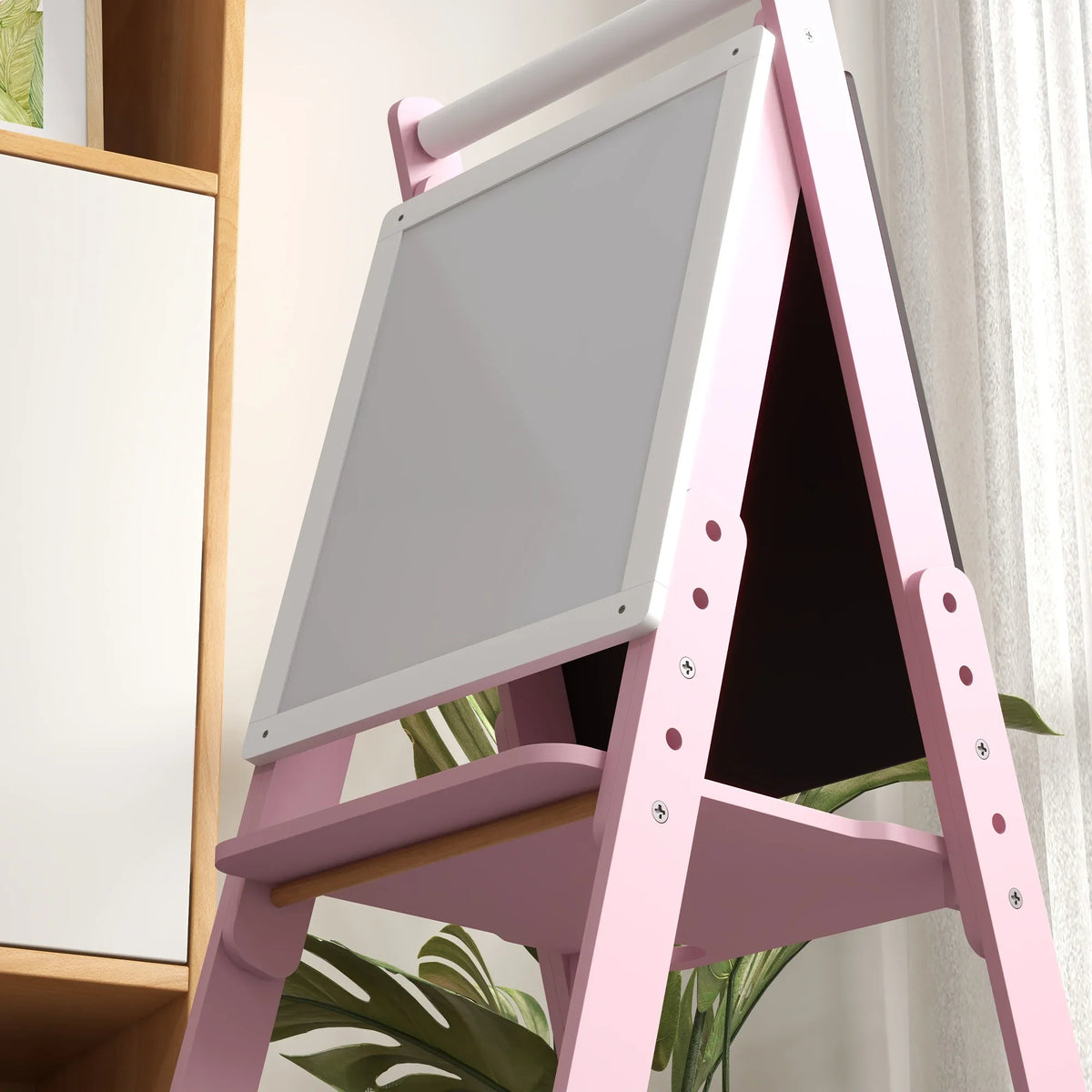 Pink kids art easel close-up with slanted whiteboard panel and metal hardware
