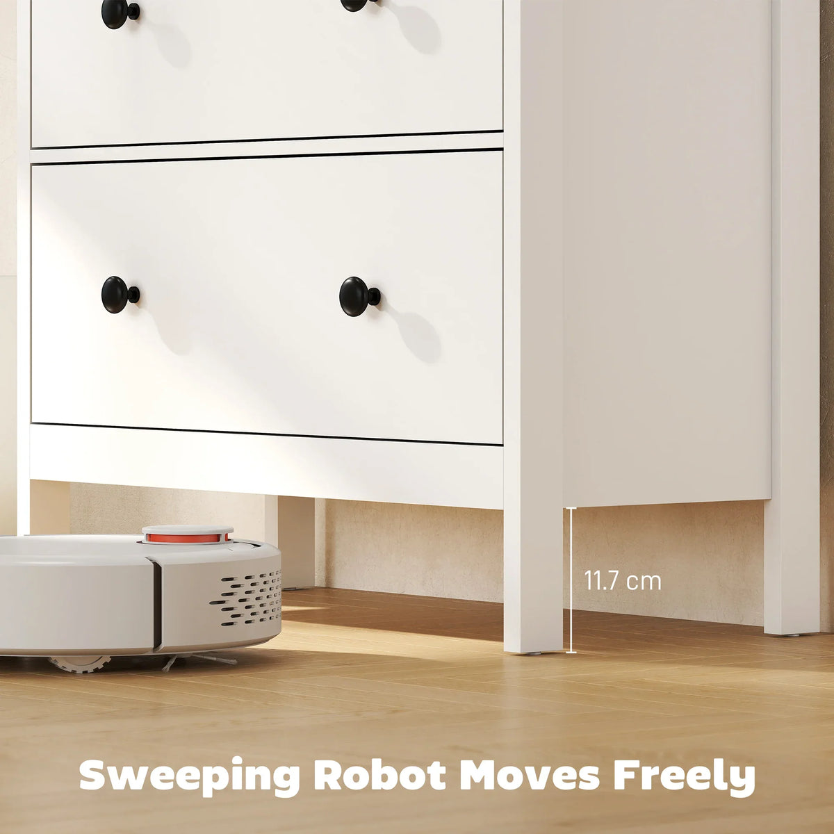 White 4-drawer chest of drawers with black knobs and clearance for cleaning robot