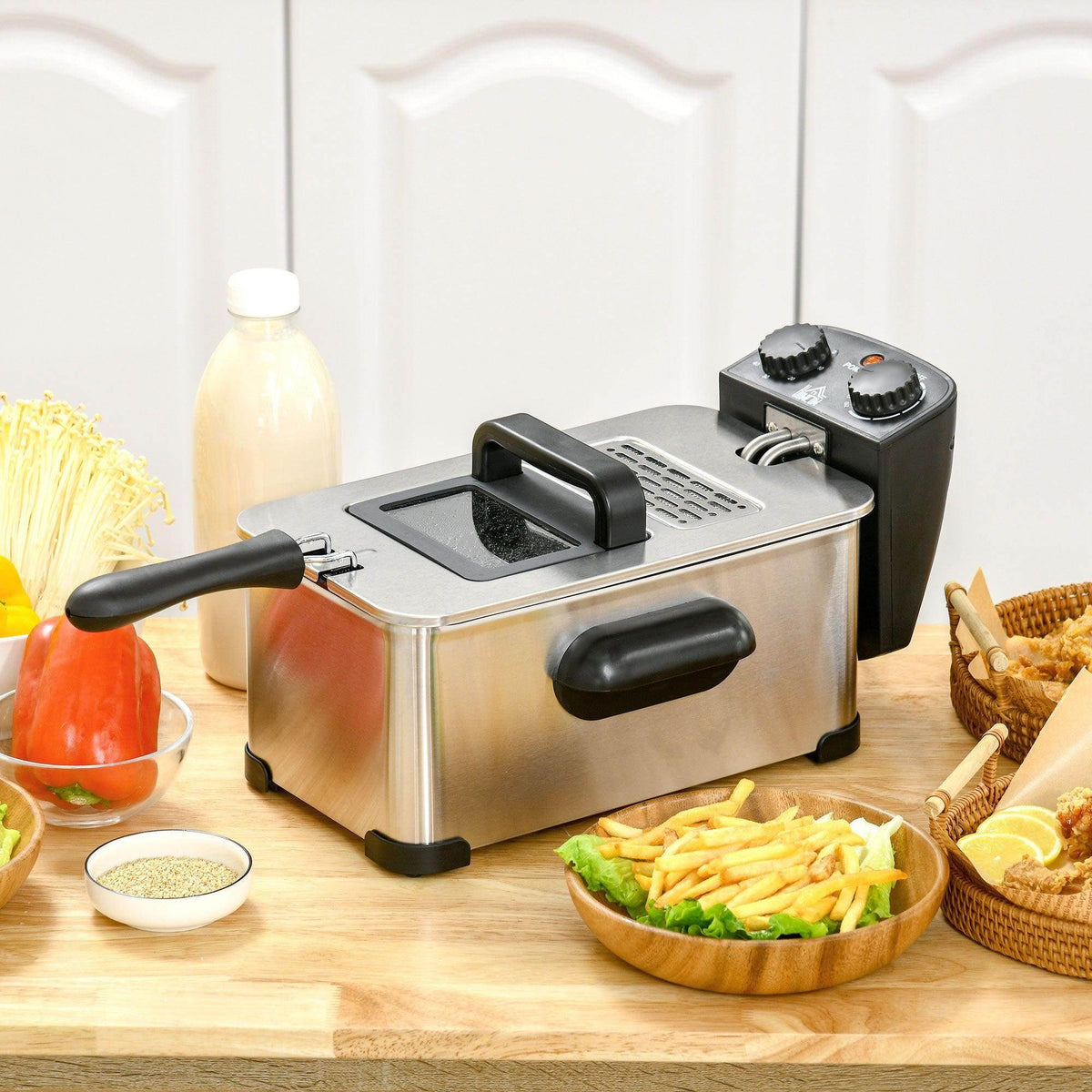 Stainless steel deep fat fryer with black handles and removable mesh frying basket