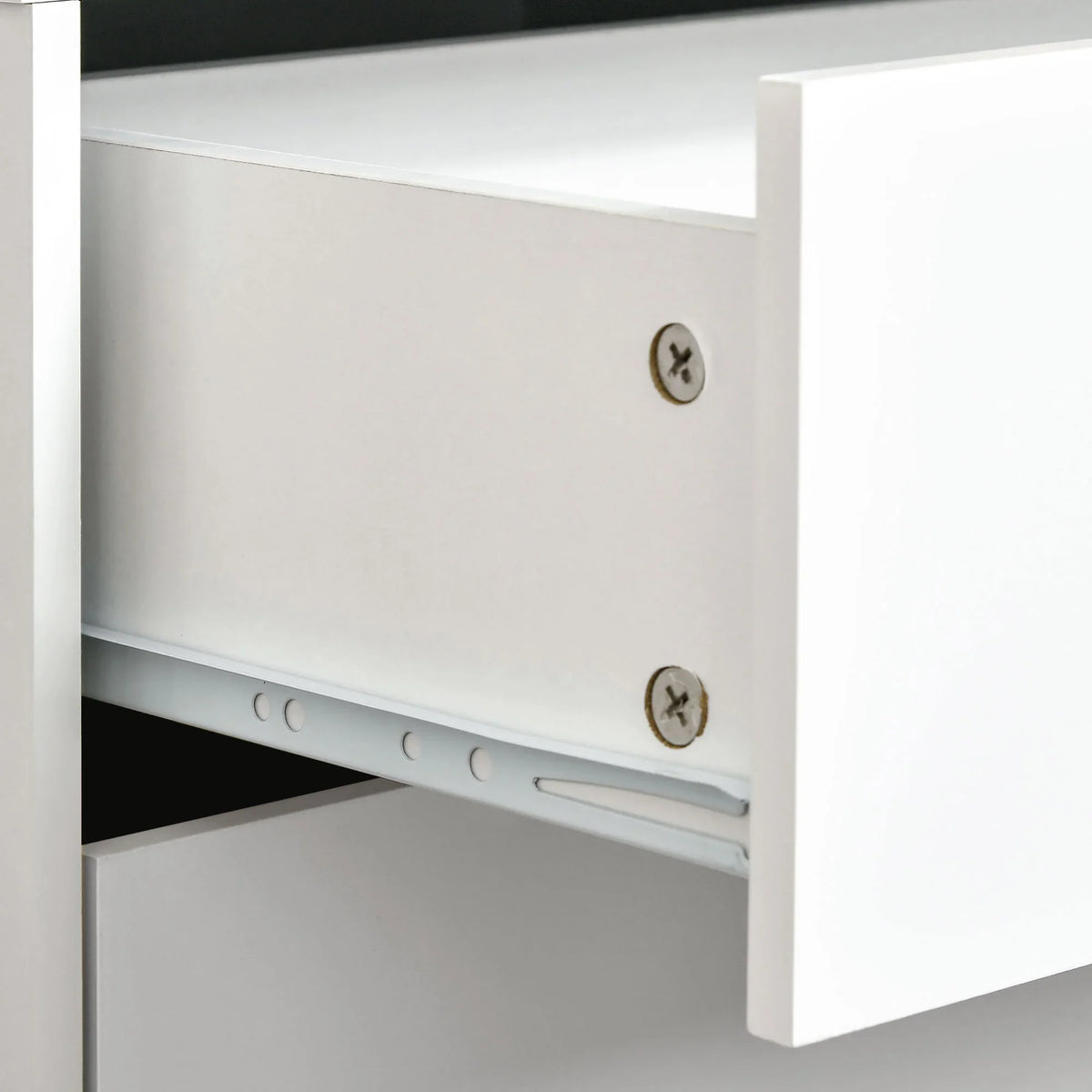 White cabinet interior with fixed shelf and metal screws, showing drawer support rail.
