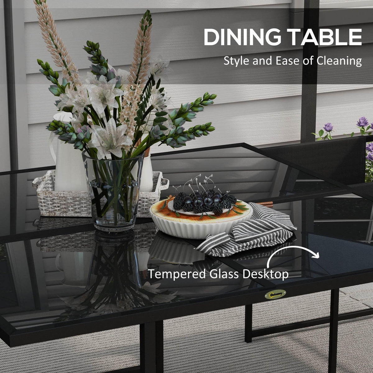 Black tempered-glass dining table with four mesh chairs, patio set