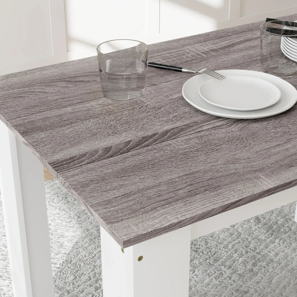 Close-up of grey wood-effect tabletop and white leg with small corner details