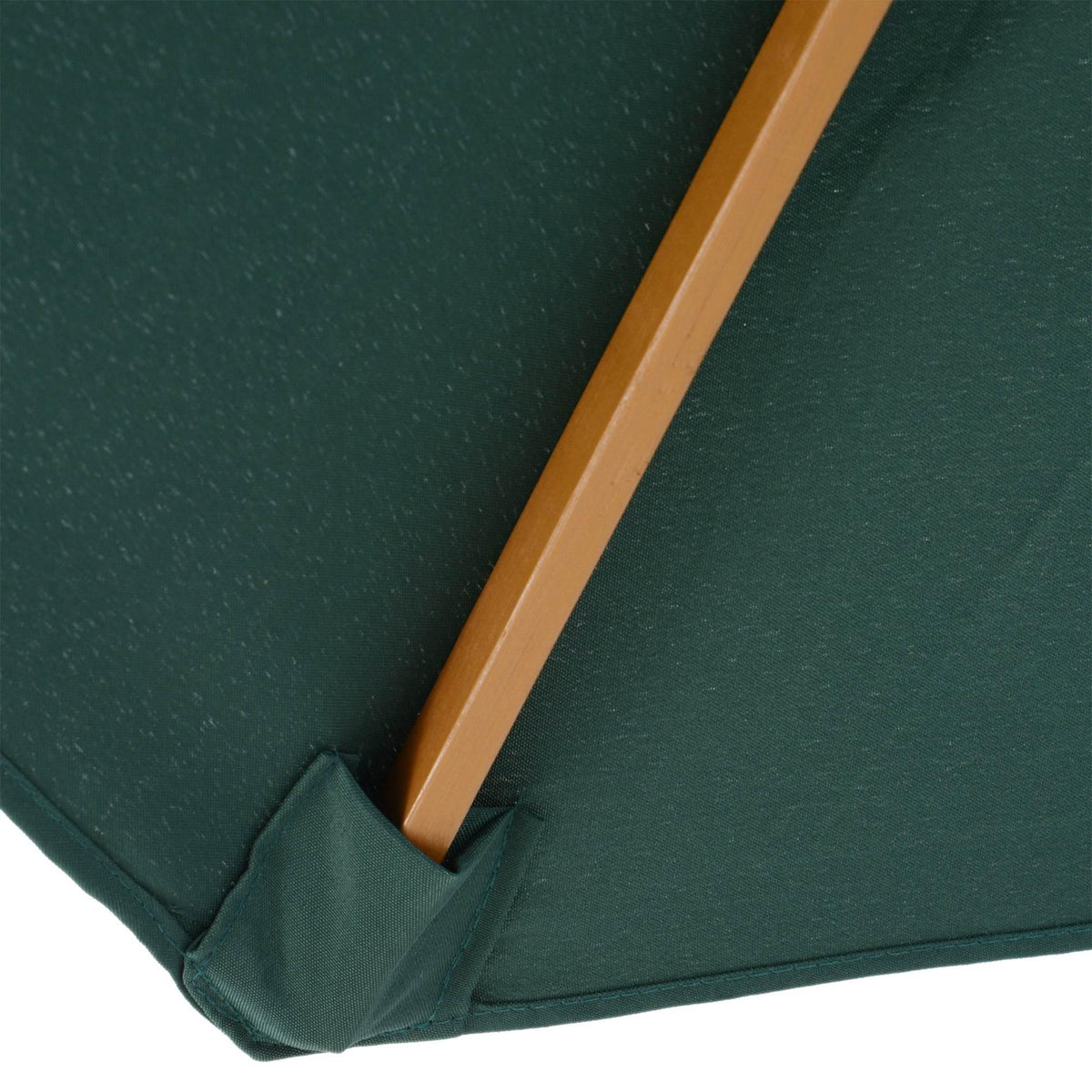 Dark green parasol fabric corner with wooden rib support and neat stitched edge