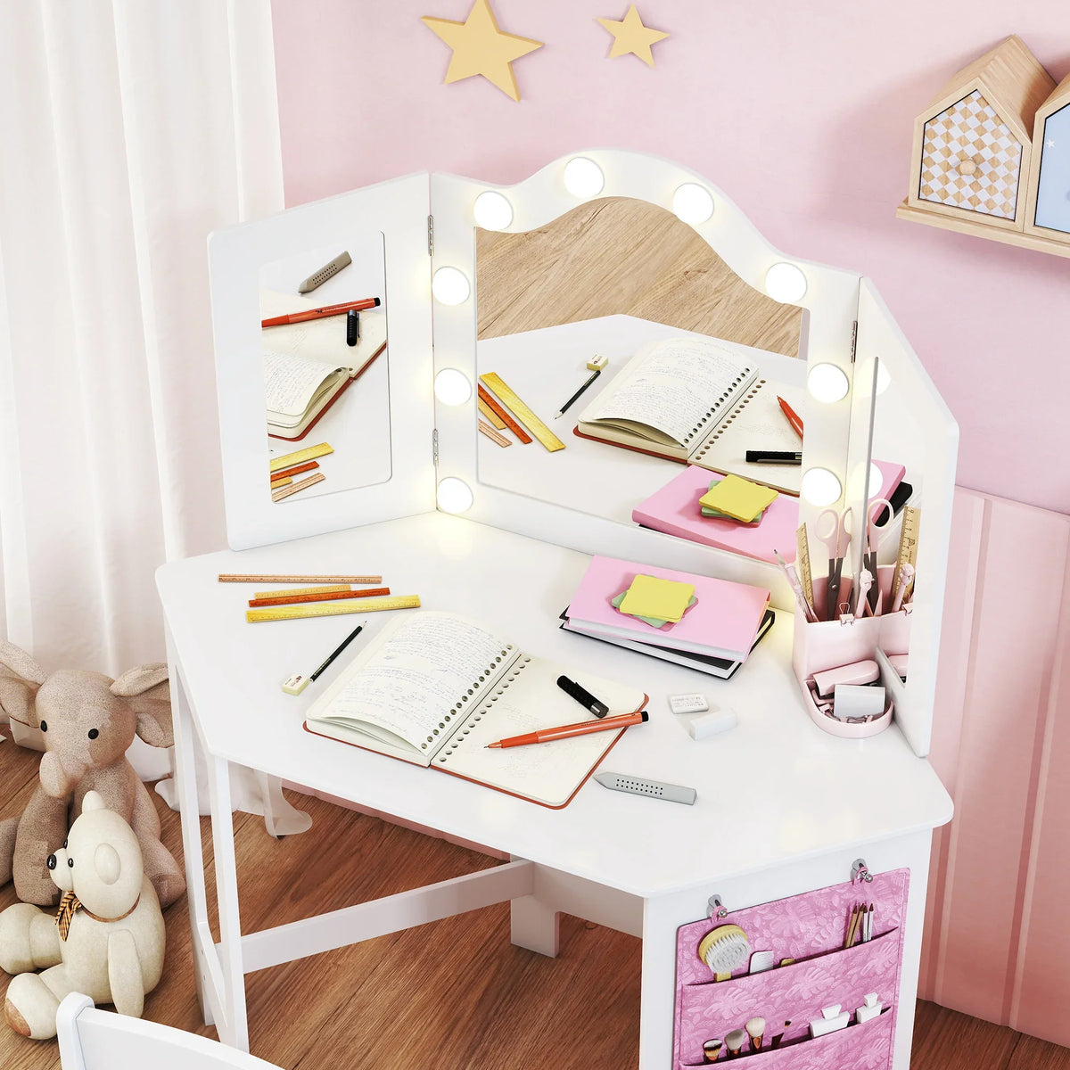 White kids vanity table with tri-fold mirror and LED bulbs, notebooks and pencils on top