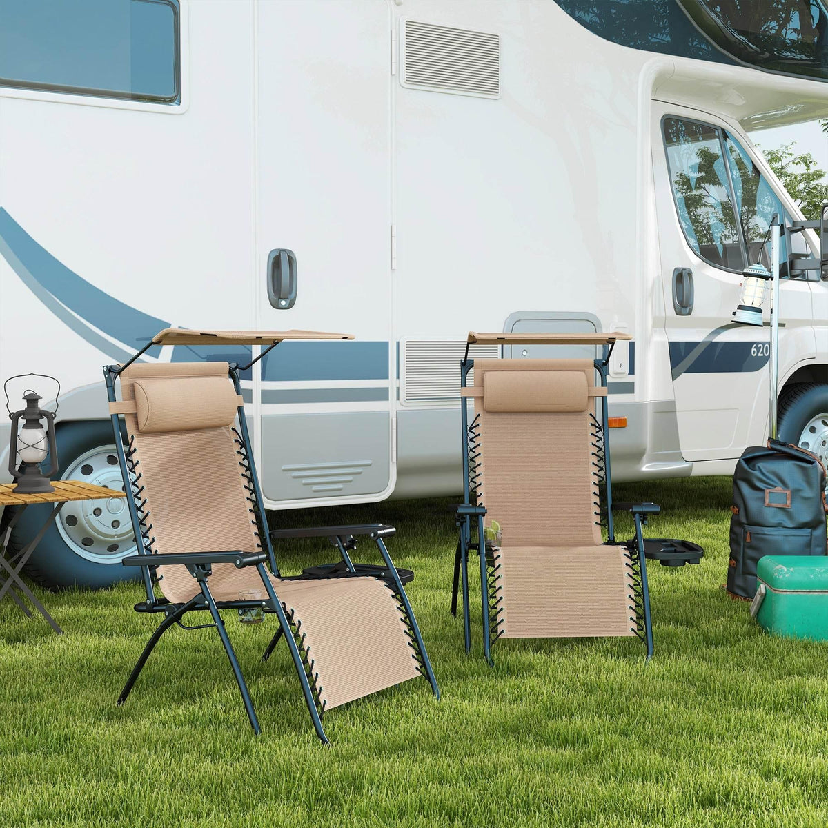 Set of 2 beige reclining garden chairs with canopy, footrest, and side tray on grass