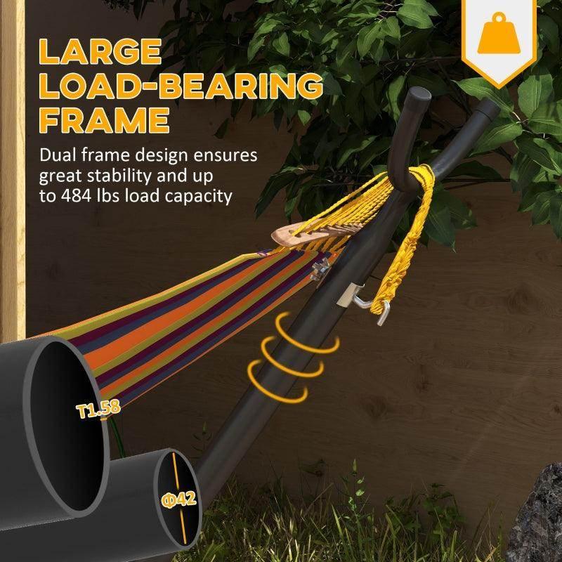 Black hammock stand holding a yellow-and-striped rope hammock near thick posts