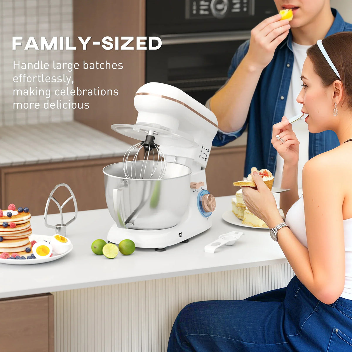 White stand mixer with stainless bowl and whisk attachment on kitchen counter