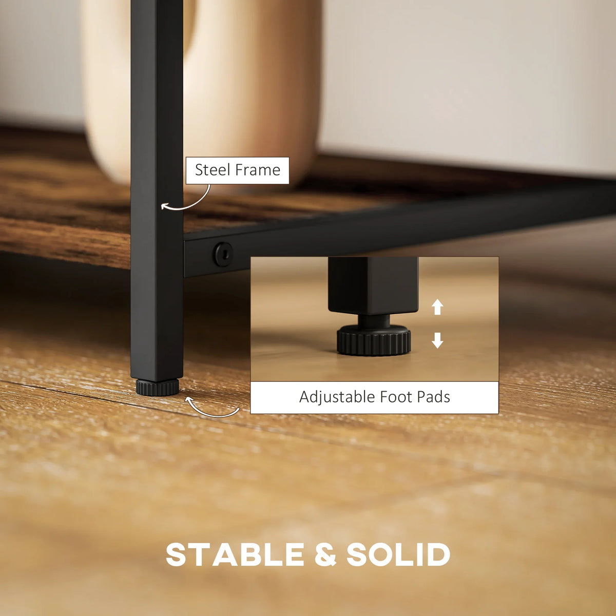 Close-up of black steel frame legs with adjustable foot pads for stable TV stand