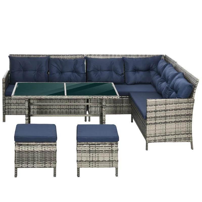 Outdoor patio wicker sectional with navy seat cushions and glass tabletop