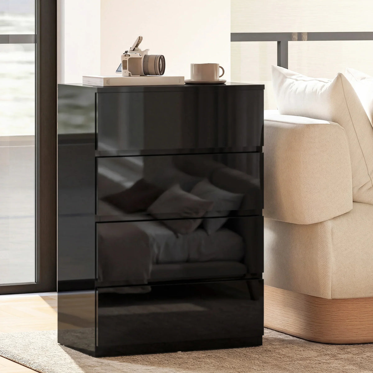 Black 4-drawer chest corner view with glossy drawer fronts and recessed handles