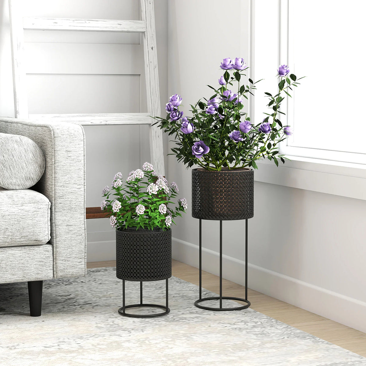Black metal hollow plant pots set of 2 on ring stands, holding potted flowers
