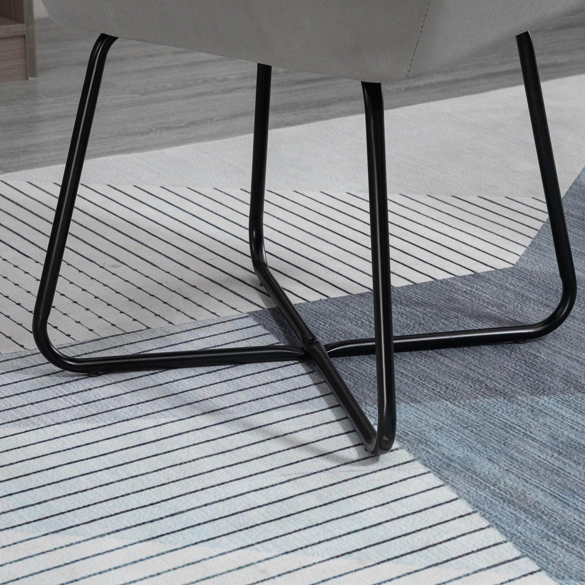 Black metal sled base of a grey accent chair with protective pads