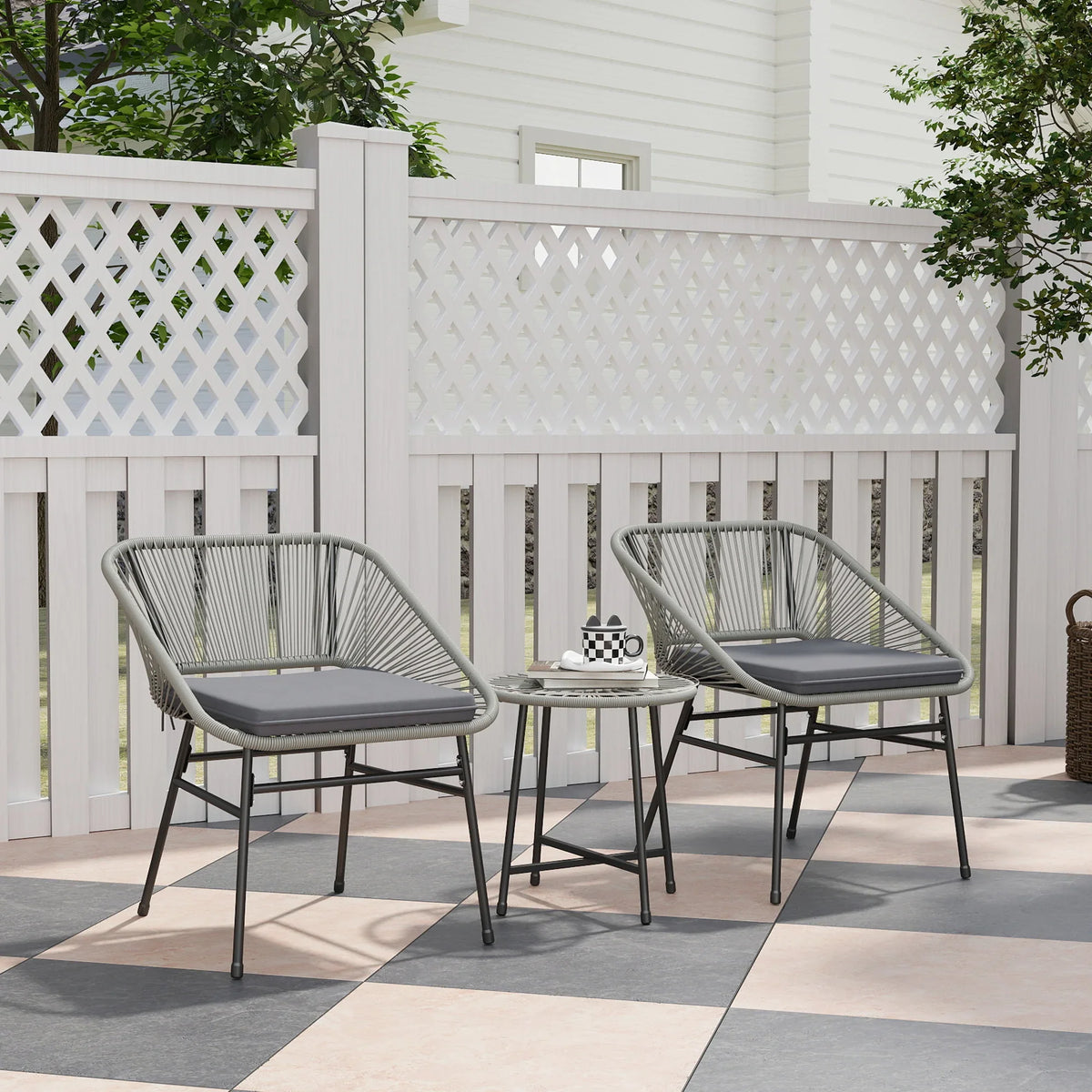 Light grey rattan bistro set with two cushioned chairs and round glass-top table