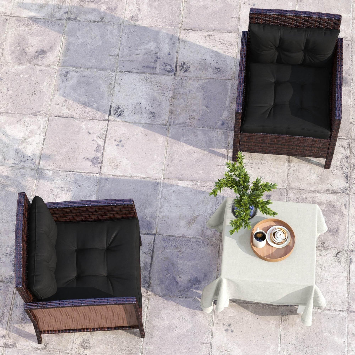 Two patio armchairs with black tufted cushions, viewed from above