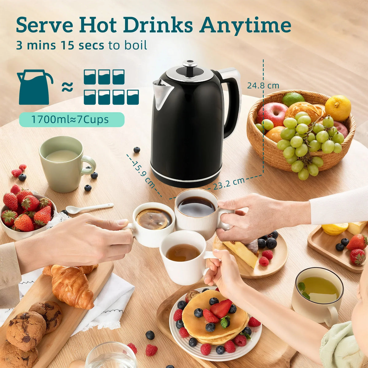 Black electric kettle on a table with cups and breakfast items around it.
