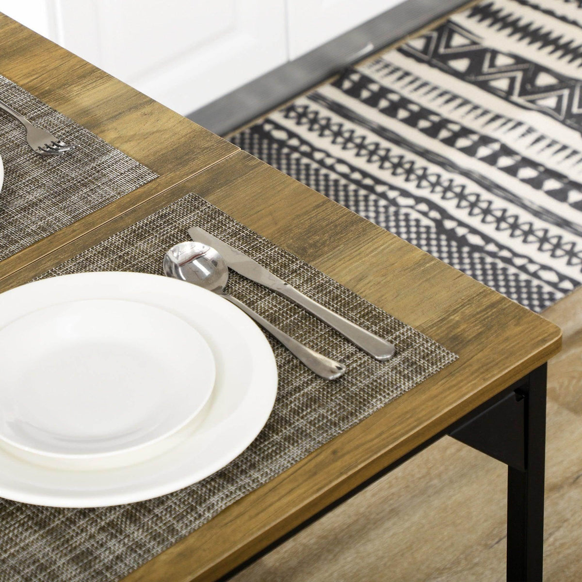 Wood-look tabletop with gray woven runner and white dinnerware set