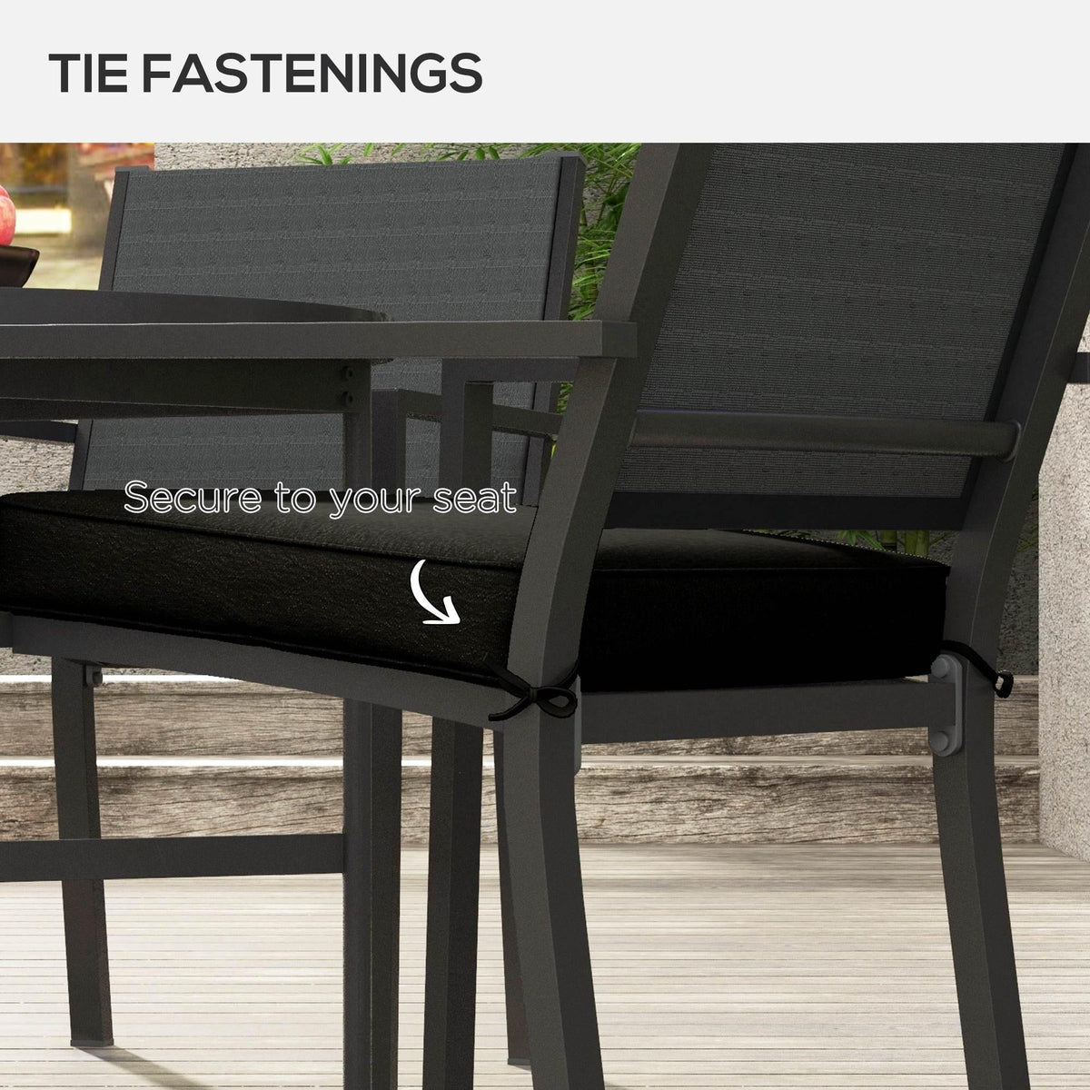 Black patio chair cushion tied to the seat with fastening cords