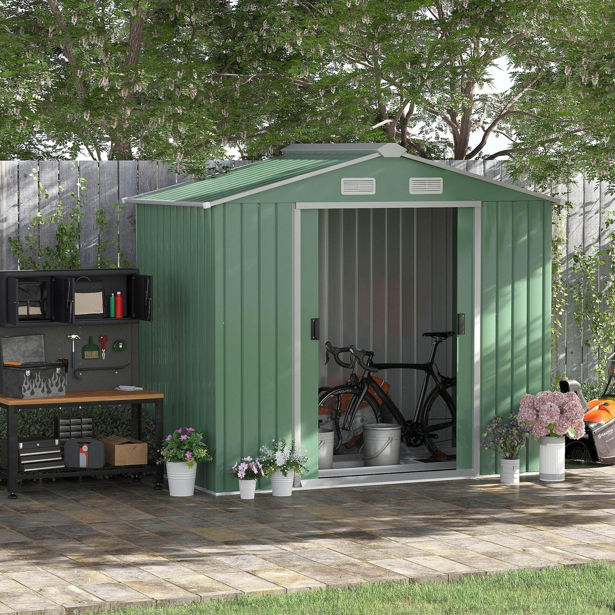 Light green metal garden storage shed with double sliding lockable doors, front view