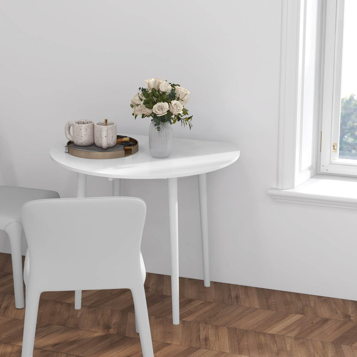 White round drop-leaf dining table with flower centerpiece on tabletop