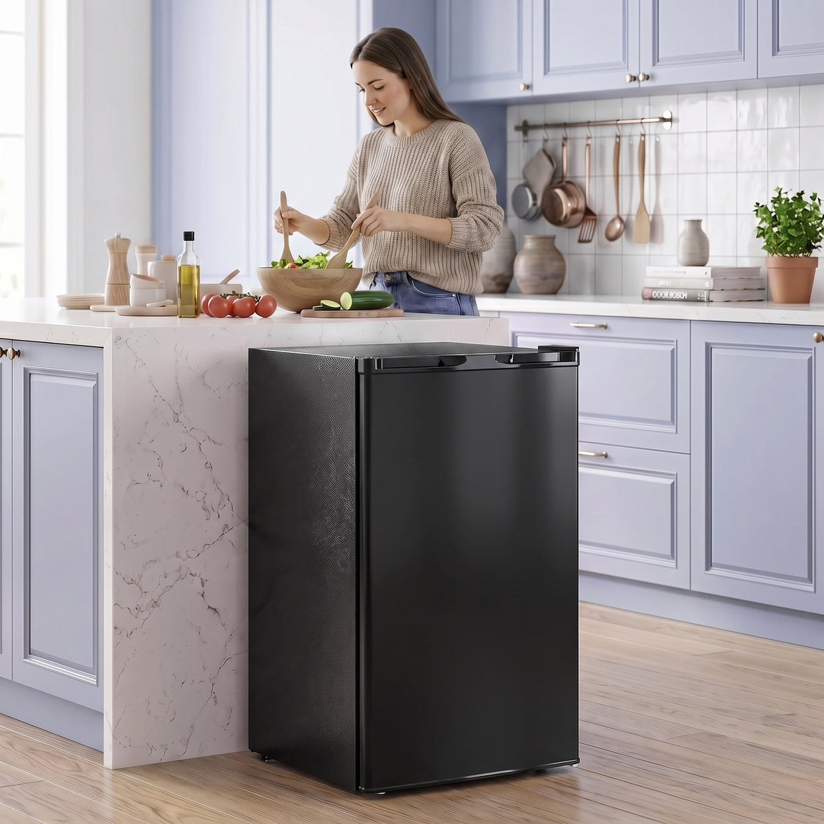 Black compact upright freezer with hinged door, front view